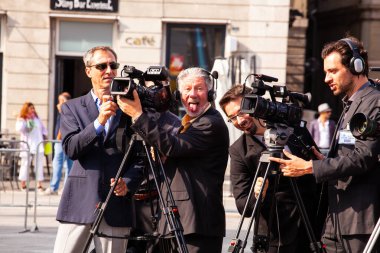 TRIESTE, ITALY - SEPTEMBER, 07: Video operators install video cameras on tripod for shooting and waiting for the event on September 07, 2016