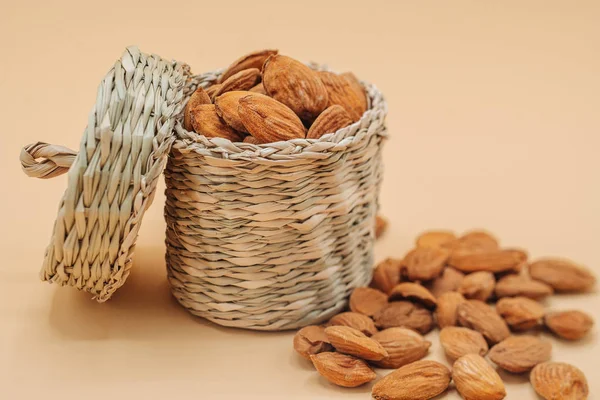 Healthy organic dried almonds in a straw basket — Stock Photo, Image