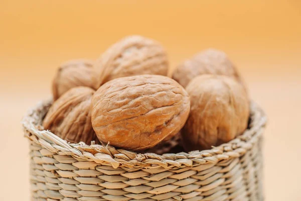 Healthy organic walnuts in a straw basket — Stock Photo, Image