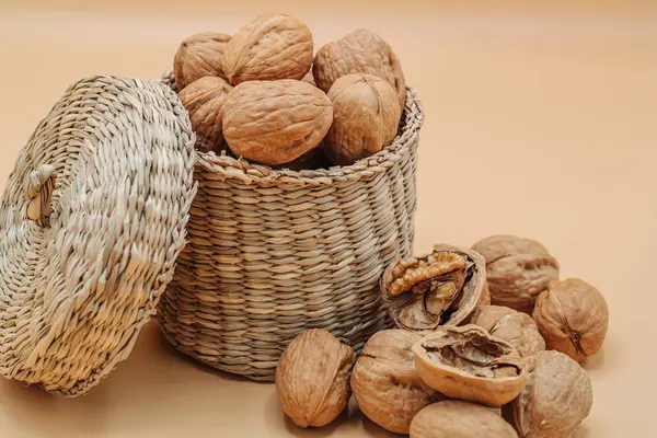 Healthy organic walnuts in a straw basket — Stock Photo, Image