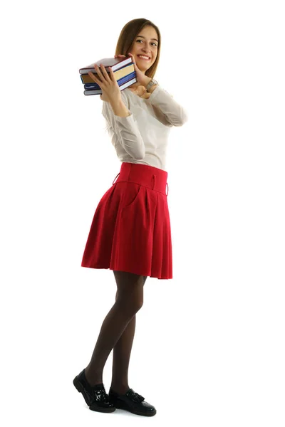Estudiante chica sostiene pila de libros en manos Imagen de stock