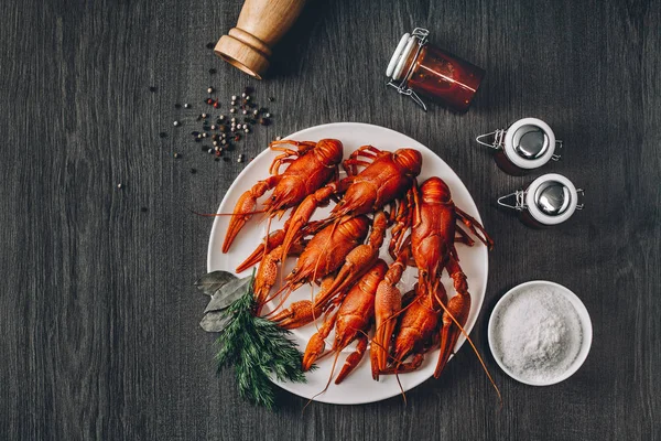Boiled big red fresh crawfish in white plate with green herbs — Stock Photo, Image