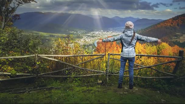 Young woman raising hands on mountain view point — Stock Video