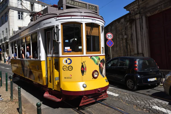 Yellow tram on a narrow street in Lisbon, Portugal — Stock Photo, Image