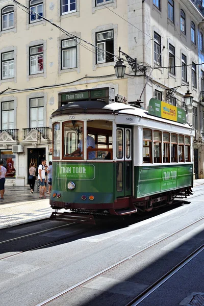 Green tram on a narrow street in Lisbon, Portugal — Stock Photo, Image