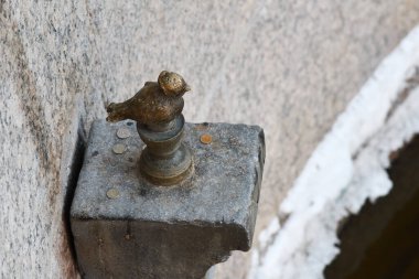 Saint Petersburg, Russia - January 31, 2020: Small   bronze sculpture of Chizhik-Pyzhik, a well-known folk character, the embankment of the river Fontanka, St. Petersburg