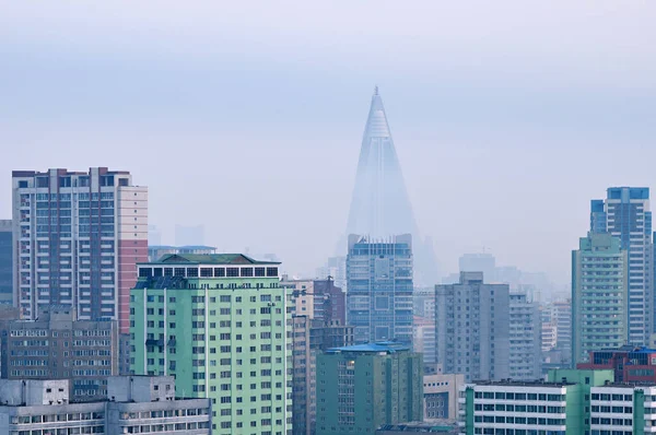 City skyline in the morning fog. View on the new residential complex on the Othat Kangan street and Ryugyong Hotel at background.