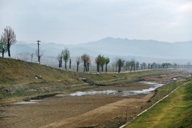 Kırsal alan, Kuzey Kore. Şehir yolu ve dağlar şafakta gösterilecek.