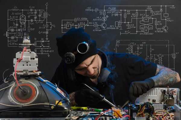 stock image  man is engaged in repair of electronics