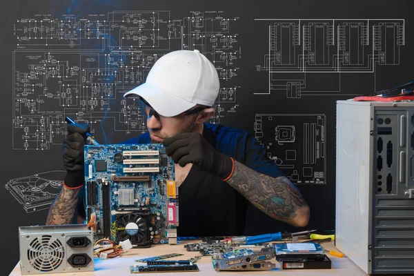 the man is engaged in repair of computers