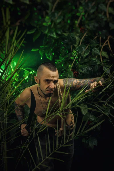 a man in the jungle with machetes attacking the enemy