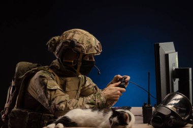 military in uniform sitting at a computer conducts cyber warfare clipart