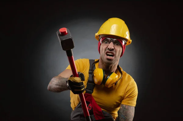 the male construction worker with a sledgehammer