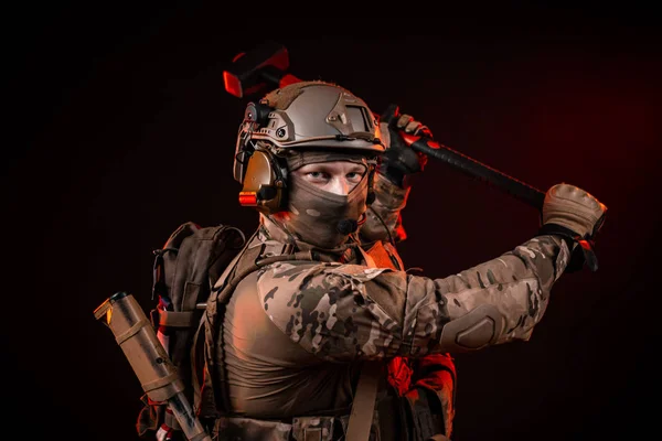 special forces soldiers in a helmet with a sledgehammer for knocking out doors