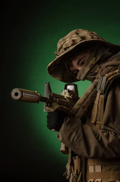 A boy in military uniform with a gun — Stock Fotó