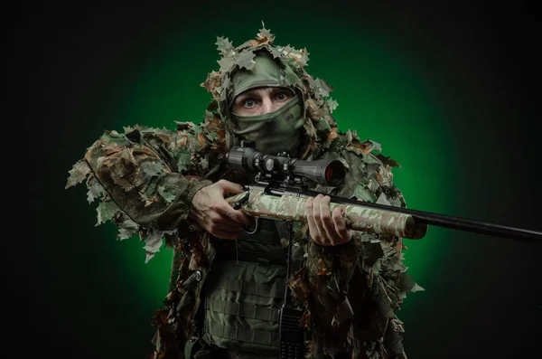 Sniper in a poncho camouflage suit and a sniper rifle — Stock Photo, Image