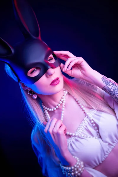 Sexy girl in a rabbit mask in neon light — Stock Photo, Image