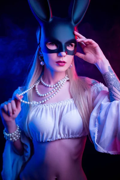 Sexy girl in a rabbit mask in neon light — Stock Photo, Image