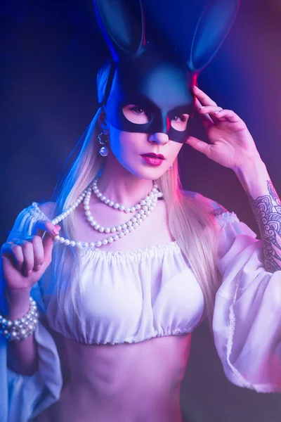 Sexy girl in a rabbit mask in neon light — Stock Photo, Image