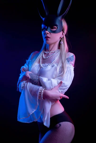 Gadis seksi bertopeng kelinci dalam cahaya neon Stok Gambar Bebas Royalti