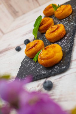 Böğürtlenli kek, pudra şekeri ve taze meyveli.