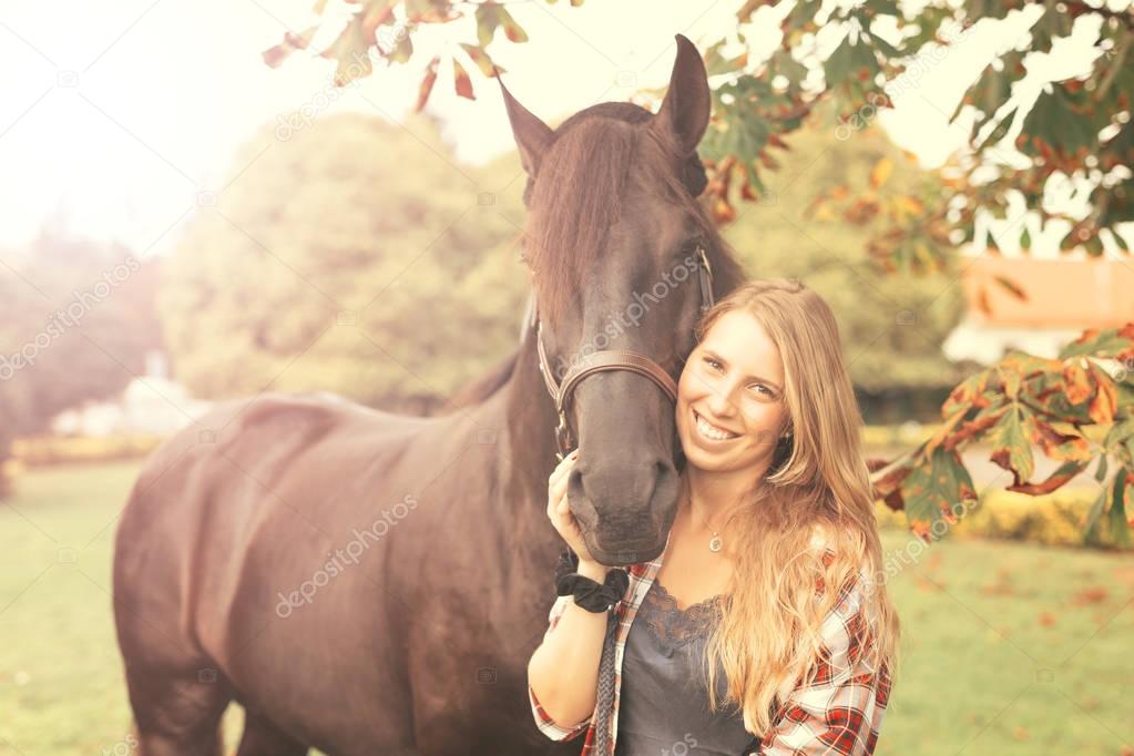 Young beautiful woman with a horse