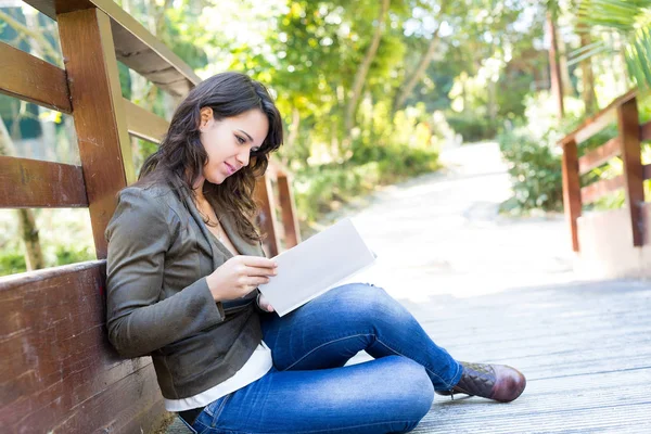 Jonge vrouw die een boek leest — Stockfoto