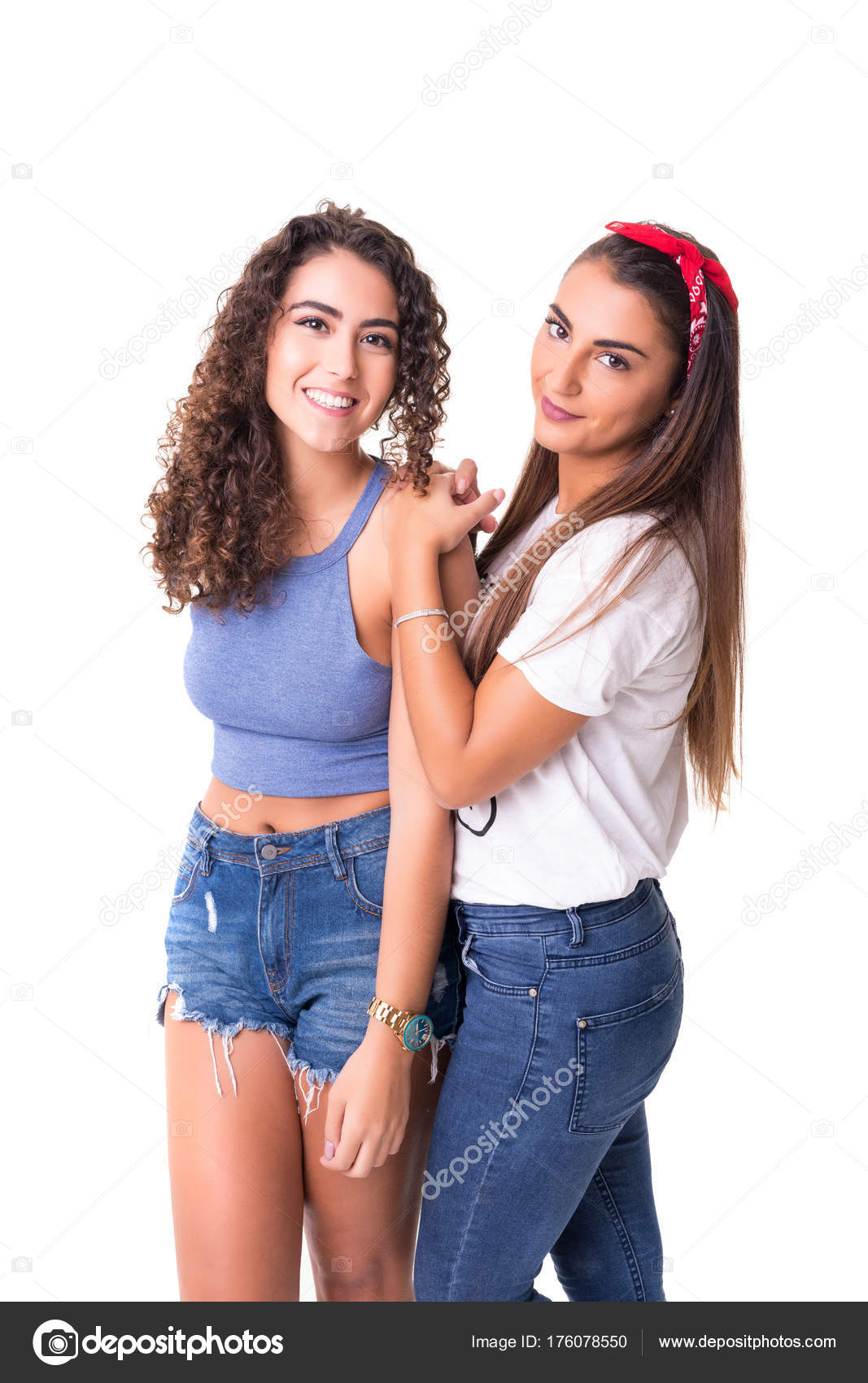 Portrait of two best friends standing back to back on a meadow stock photo