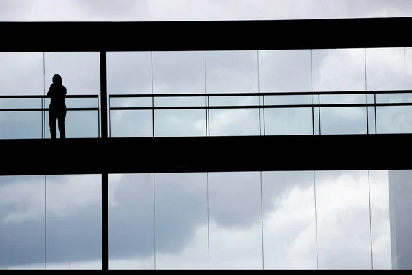 Vista de la silueta de la joven empresaria en un moderno edificio de oficinas interior —  Fotos de Stock