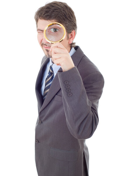 Isolated young business man with magnifying glass