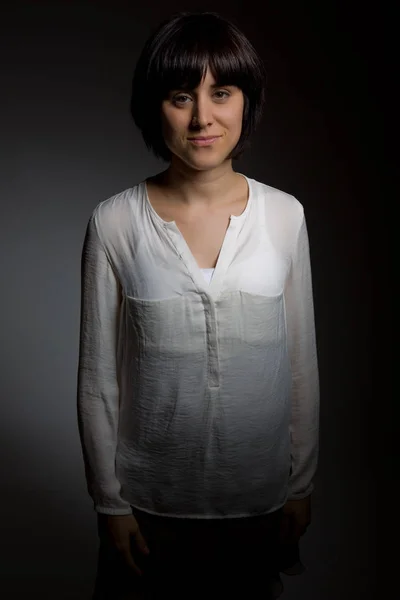 Beautiful brunette portrait against black background — Stock Photo, Image