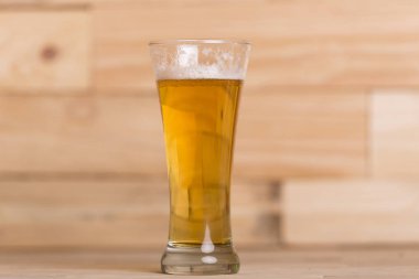 Ahşap arka planda bir bardak bira