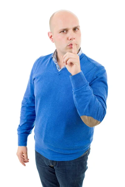 Portrait of a young bald man making a shushing gesture with his finger, isolated — Stock Photo, Image
