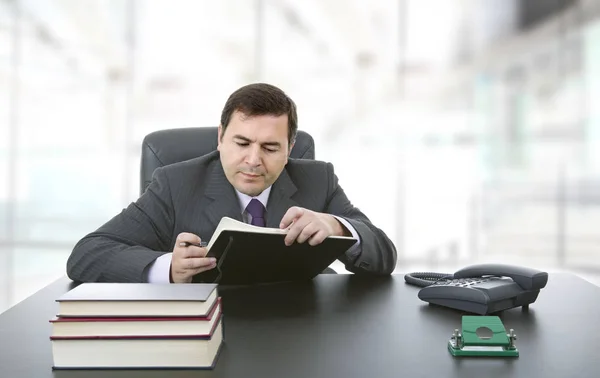 Businessman writing on a desk, at the office — Stock Photo, Image