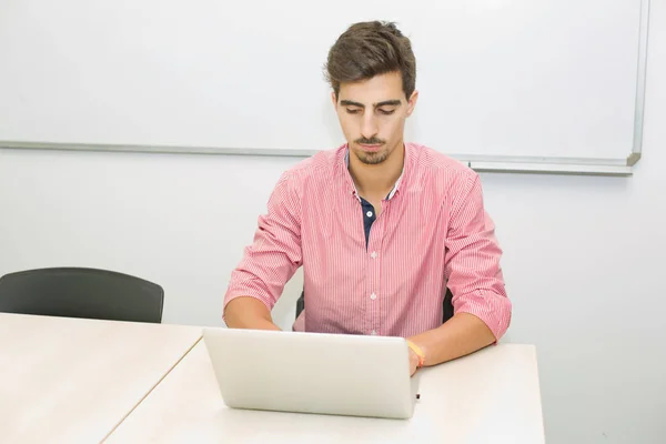 Young casual teenager student in the classroom — Stock Photo, Image