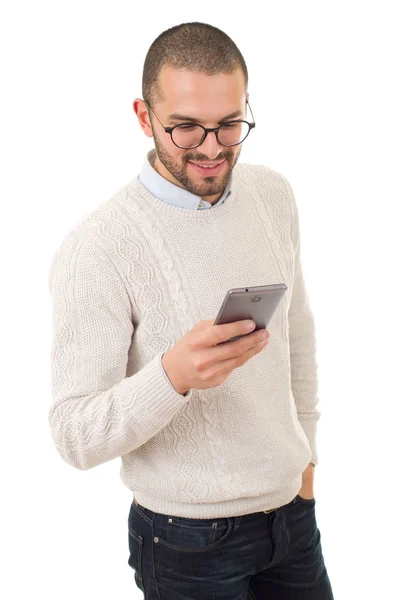 Ung avslappnad lycklig man med en telefon, isolerad — Stockfoto