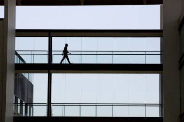 Modern ofis binası içinde genç işadamı görünümünü siluet