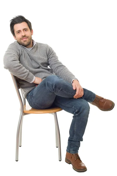 Happy casual man on a chair, isolated on white background — Stock Photo, Image