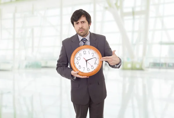 Mad businessman with clock at the office — Stock Photo, Image