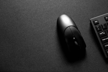 black gamin mouse and keyboard with copy space. Gaming mouse with keyboard on black gaming mouse mat. clipart