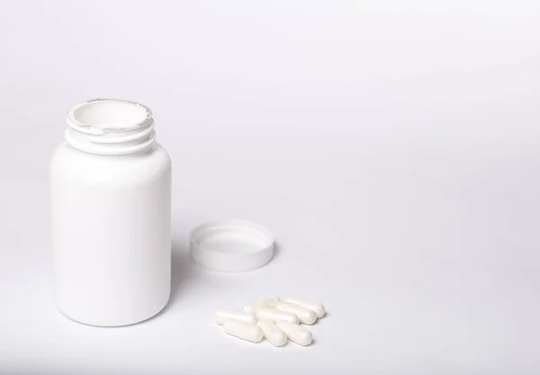 White box for medicines with no logo and capsules on a white background.