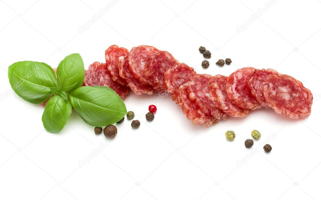 Salami sausage slices and basil leaves