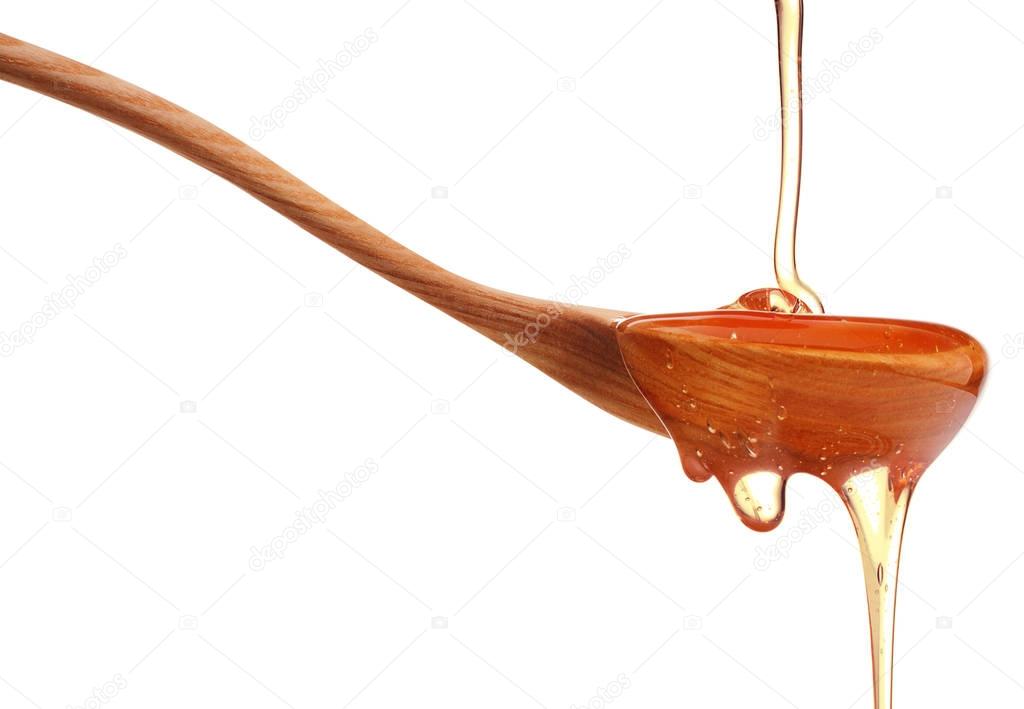 Honey dripping from wooden dipper