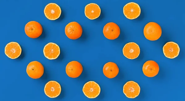 Fruit pattern of fresh orange tangerine or mandarin on blue back