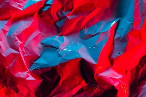 Crushed paper background in vibrant bold gradient holographic ne — Stock Photo, Image