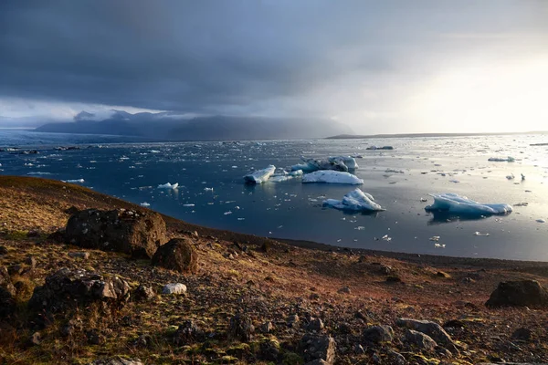 Smältande isberg i Yokulsarlon issjö under solnedgången — Stockfoto