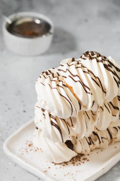 White meringue sprinkled with chocolate. Italian or French dessert