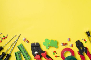 Construction tools of the installer on a yellow background. Electrician's tools. Top view with copy space for text