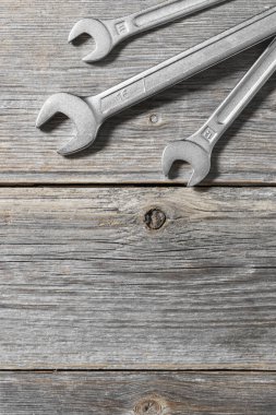 Wrenches on a grey wooden background. Hand tools. Top view with space for text
