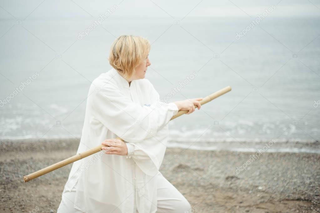 European caucasian adult woman practicing Taijiquan